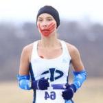 Rosalie Fish in runners gear with red paint hand print runs outside